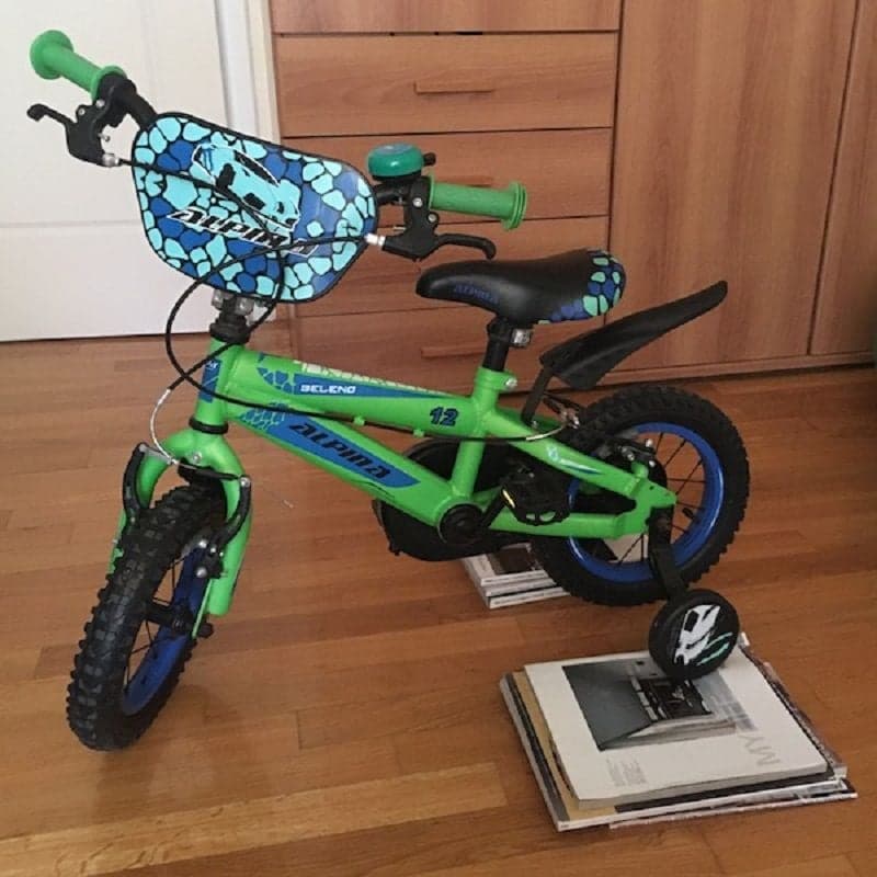Bicycle in the house. Magazines or books under the training wheels. Inventive way to keep kids active.