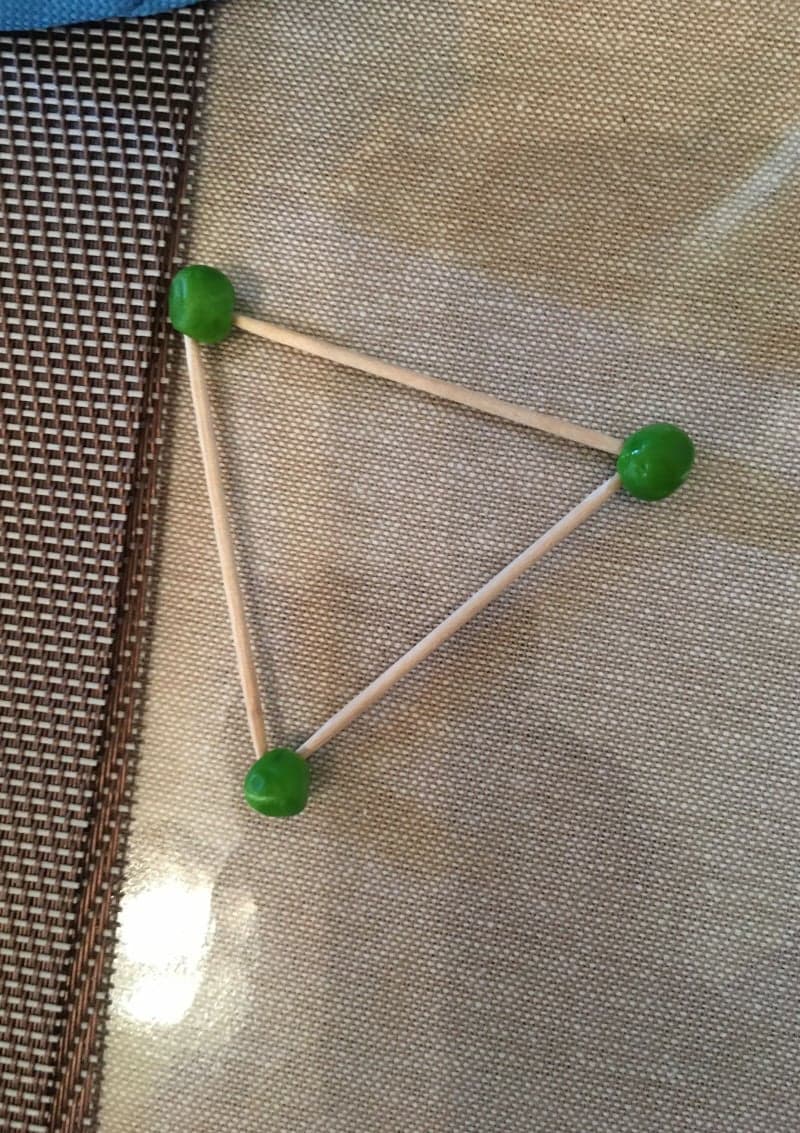 Educational play for preschoolers with peas and toothpicks. Learning shapes. Triangle.